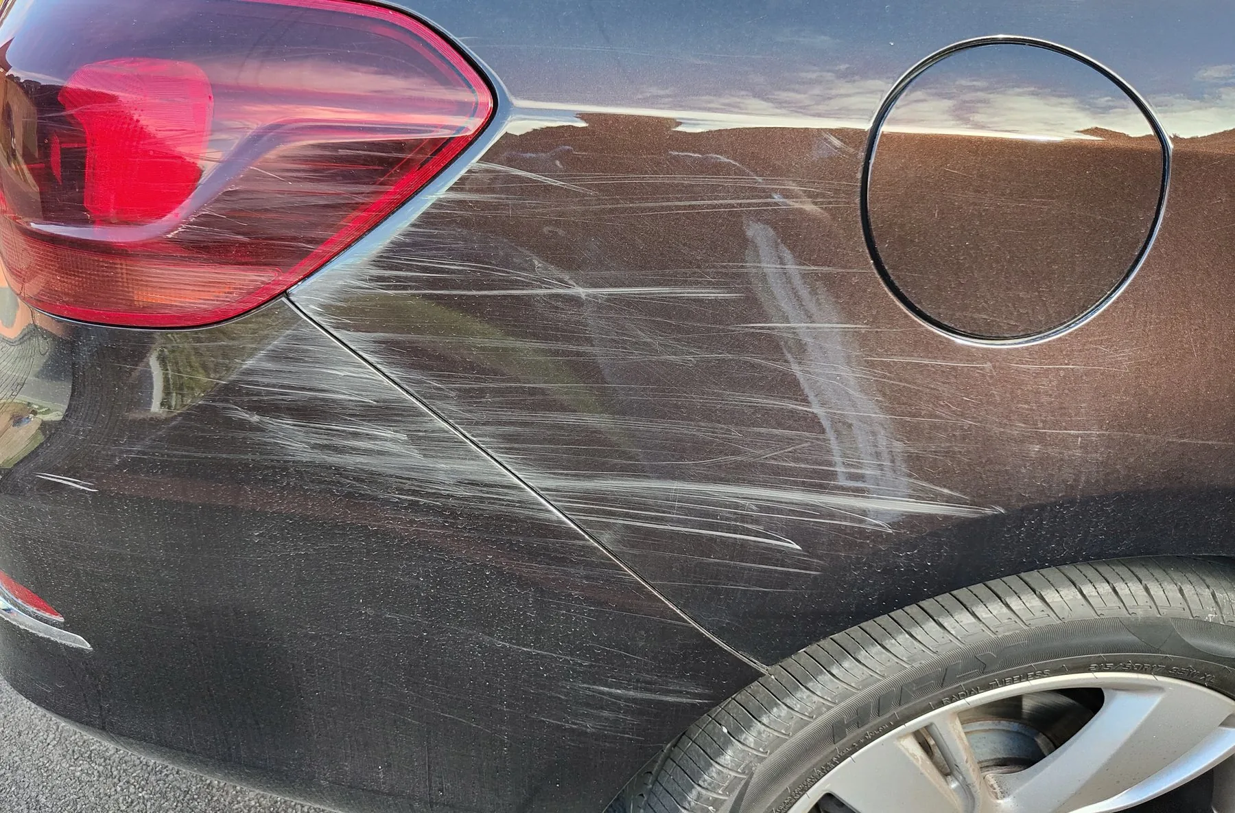 A scratched rear quarter panel before paint correction