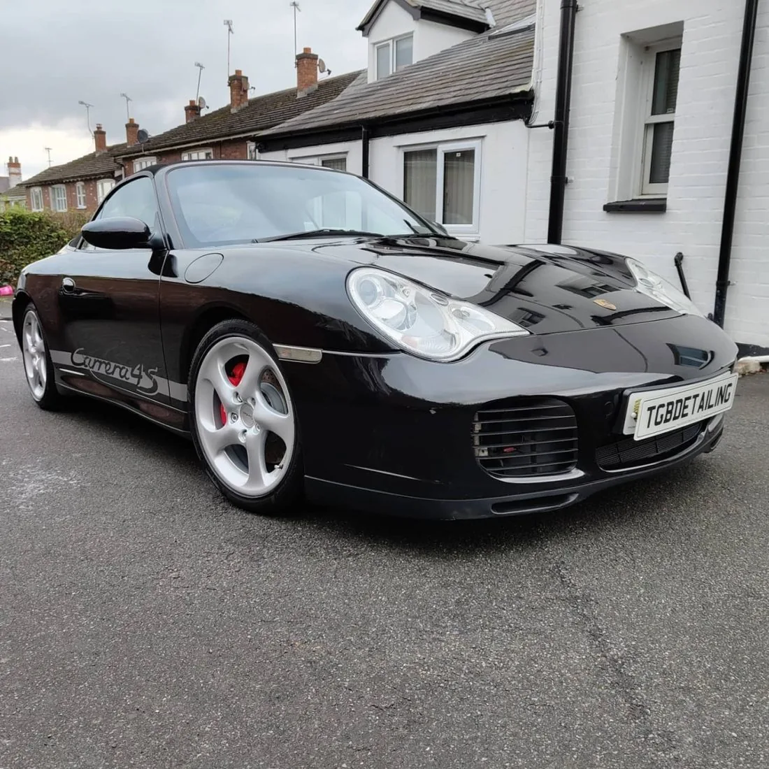 Black Porsche 911 Carrera 4S cabriolet after detailing